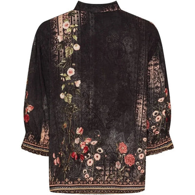 Mørk skjorte med blomstermønster, elastiske mansjetter og knappestolpe. Visning bakfra.