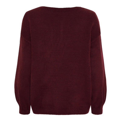 Baksiden av en ensfarget strikkegenser uten mønster, i en dyp rød farge.