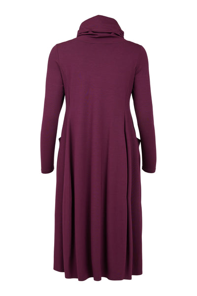 Lilla kjole med høy cowl-hals, lange ermer og lommer. Sett bakfra.