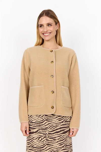 Beige jakke med rund hals, lange ermer, knapper og to lommer. Brukes med zebramønstret skjørt.