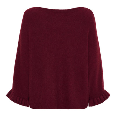 Klesplagg i dyp rød med rund hals, lange ermer med rysjer og løs passform.