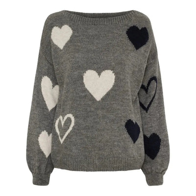 Grå genser med hvite og mørke hjerter, ribbestrikket hals og mansjetter, lange ermer.